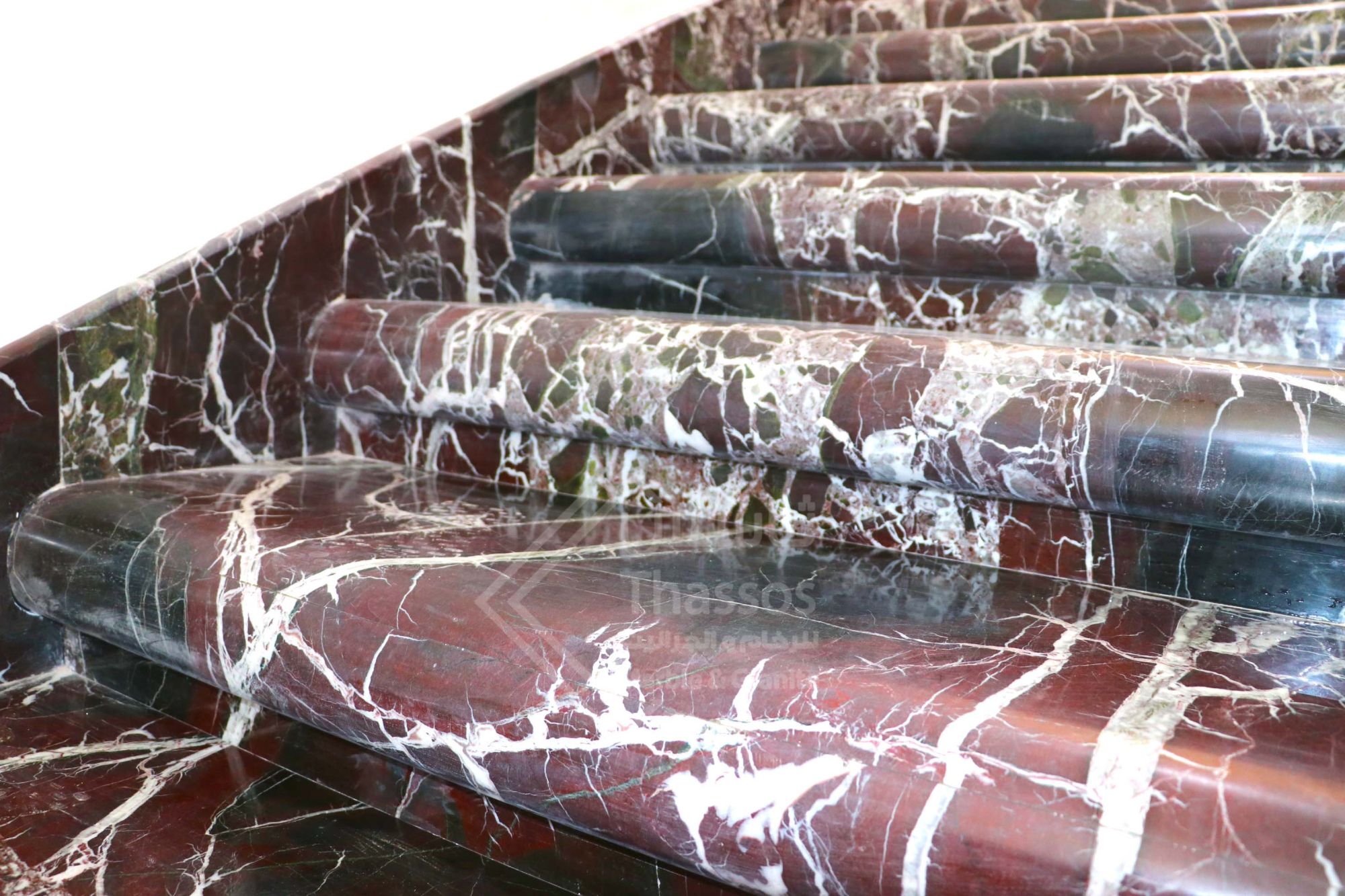 A distinctive staircase made of luxurious Rosso Levanto marble