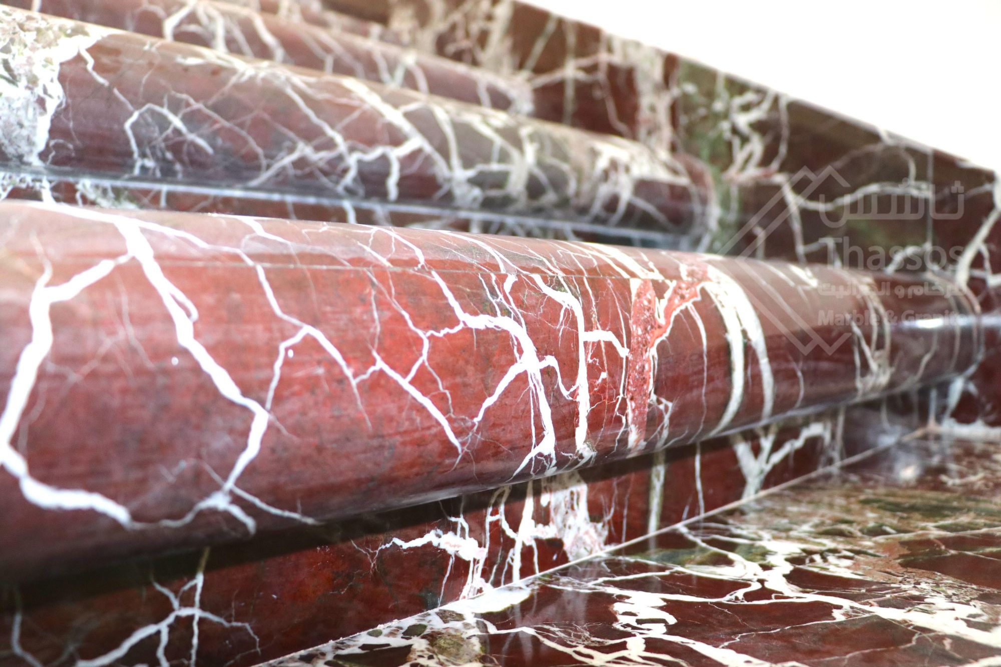 A distinctive staircase made of luxurious Rosso Levanto marble