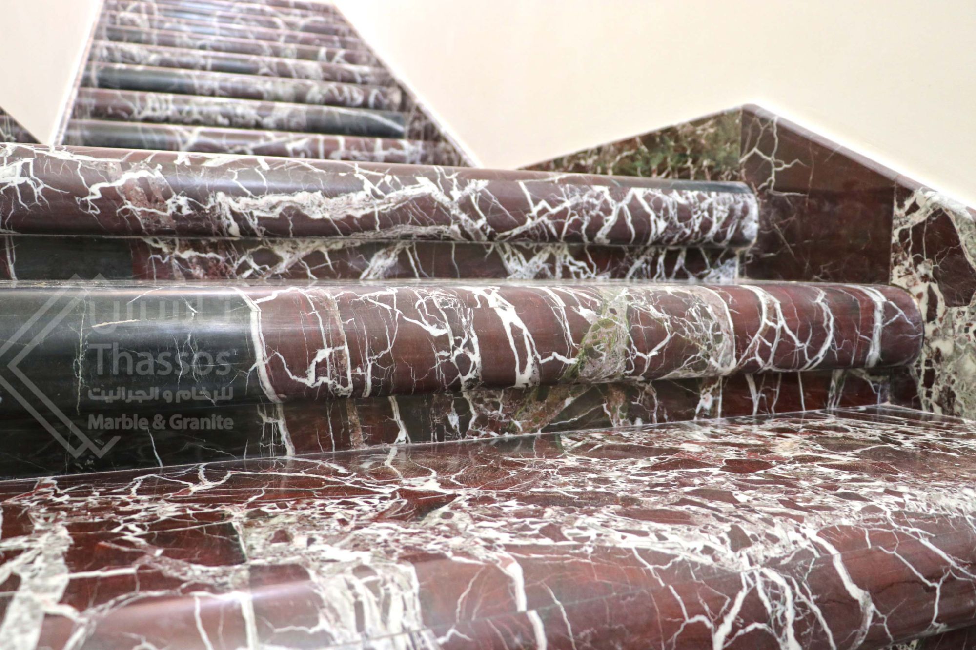 A distinctive staircase made of luxurious Rosso Levanto marble